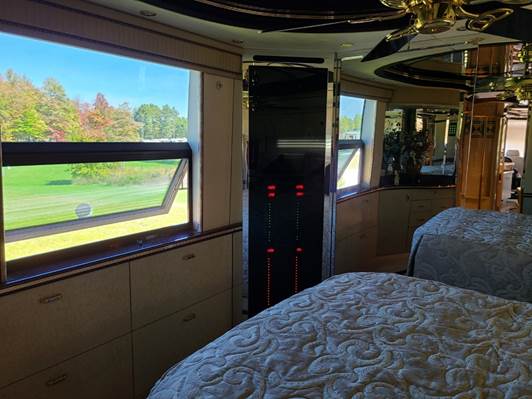 A room with a glass wall and a mirror wall

Description automatically generated with medium confidence