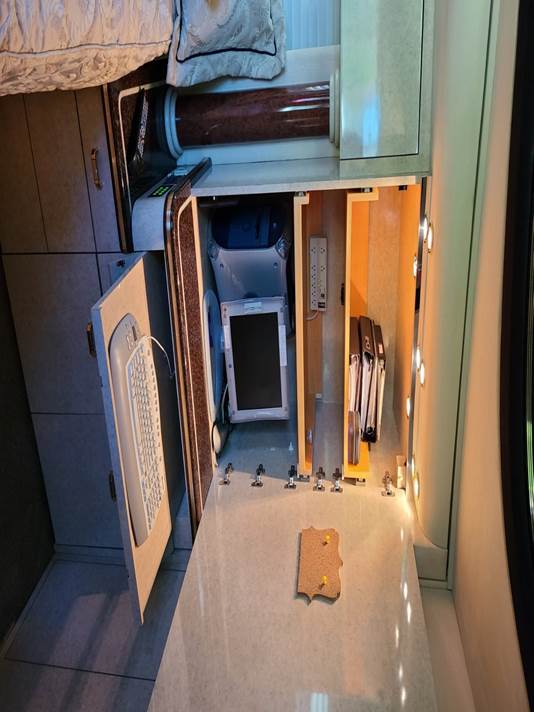 A corner of a room with a mirror and flowers

Description automatically generated