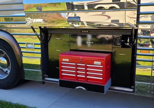 A bus with stairs and a tv

Description automatically generated