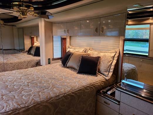 A kitchen with a sink and a television

Description automatically generated